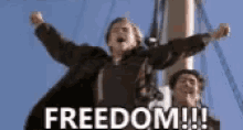 a man is standing on a boat with his arms in the air and the word freedom is on the bottom of the image .
