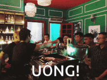 a group of people are gathered around a bar with the words uong written on the bottom