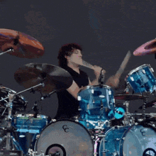 a man is playing drums with a cymbal that says silencer on it