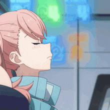 a girl with pink hair is looking at a laptop