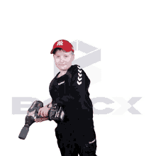 a young boy wearing a ny hat is holding a tool
