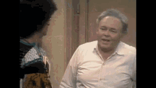 a man and a woman are standing next to each other in a room .
