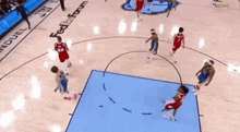 a group of basketball players are playing a game on a court with a fedex forum logo on the floor .