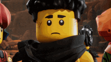 a close up of a lego man with a sad face