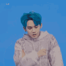 a young man with blue hair is wearing a bandana sweater
