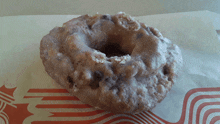 a donut is sitting on a piece of paper with a starbucks logo on it
