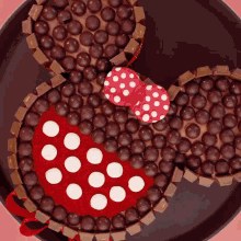 a cake in the shape of minnie mouse made of chocolate