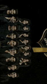 a group of people standing in front of a sign that says 86 community pop rock