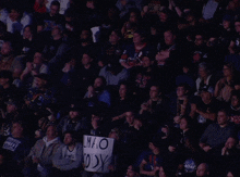 a fan holds up a sign that says lmao cody in front of a crowd