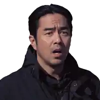 a man in a black jacket is making a funny face