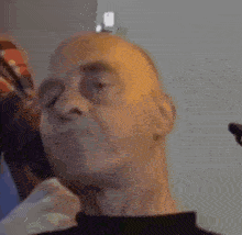 a close up of a man 's head with his eyes closed