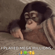a chimpanzee laying on a blanket with the words i played mega millions