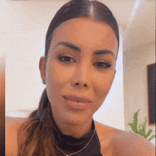 a woman with her hair in a ponytail is smiling