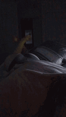a stuffed animal is laying on a bed with a person