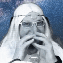 a man wearing glasses and a white wig is covering his mouth