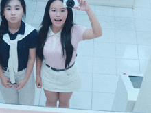 a woman is taking a picture of herself in a mirror