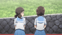 two girls are standing next to each other and one has a x on her back