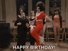 a group of people are dancing in a room with the words `` happy birthday '' written above them .