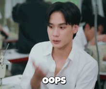 a man in a white shirt with the word oops on the bottom right