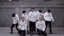a group of young men are wearing hoodies that say " do n't tell " on them