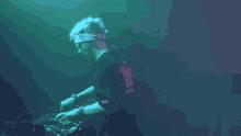 a man with a bandana on his head is playing a dj set
