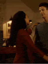 a man and a woman are dancing in a room .