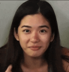 a close up of a woman 's face with a smile on her face .