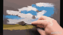 a person is painting a landscape with a spatula and the words made in animotica are visible