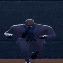 a man in a suit and tie is dancing in a video game .
