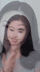 a close up of a woman 's face with a reflection of another woman 's face in the background .