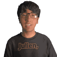 a man wearing glasses and a black shirt that says julien on it