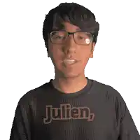 a man wearing glasses and a black shirt that says julien on it