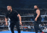 a man is in a boxing ring with a crowd watching