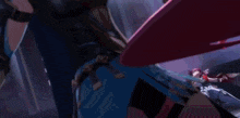 a woman in a blue dress is fighting another woman in a purple dress