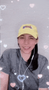 a woman wearing a yellow lakers hat and headphones