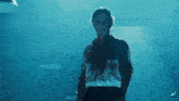 a man in a bloody shirt is standing in the dark