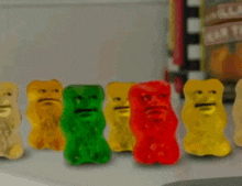 a row of gummy bears with faces on them .