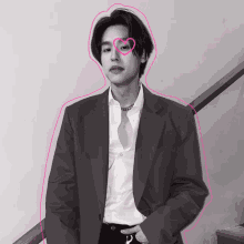a man in a suit has a pink heart on his eye