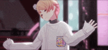 a girl with blonde hair is wearing a white sweater with a pocket that says ' strawberry ' on it