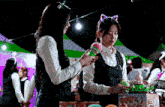 two girls are standing next to each other at a carnival playing a game .