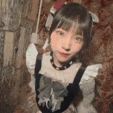 a girl wearing a black and white dress with ruffles and a bow looks at the camera