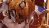a close up of a statue of a cat with red eyes and a gold mask .