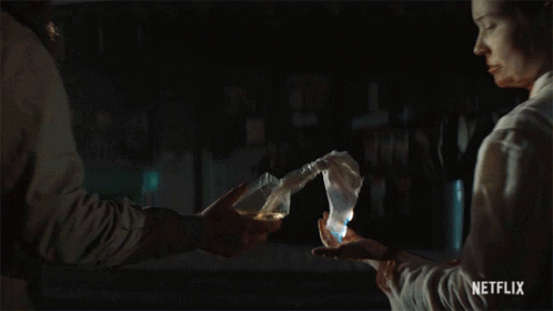 a man is holding a torch in front of a woman with a netflix logo on the bottom