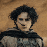 a man with curly hair wearing a headset on his face