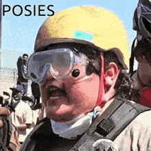 a man wearing a yellow helmet and goggles with the word poses written on the bottom