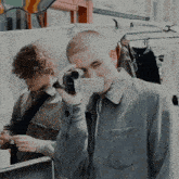 a man is taking a picture of another man with a camera