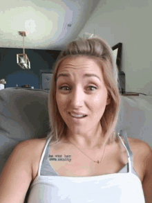 a woman with a tattoo on her chest that says she was here once already