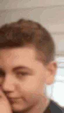 a close up of a man 's face with a blurry background