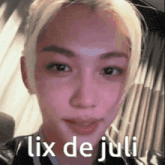 a close up of a woman 's face with the words lix de juli written above her .