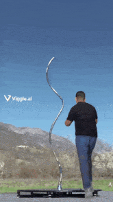 a man is standing in front of a sculpture that says vigge.ai